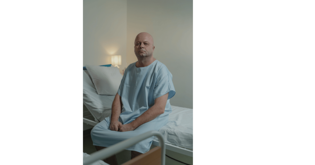 Bald man sitting on a bed Tima Miroshnichenko