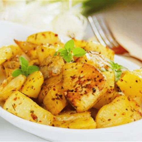 Roast potatoes on a plate with fork