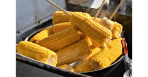 Taking out maize cobs after boiling them