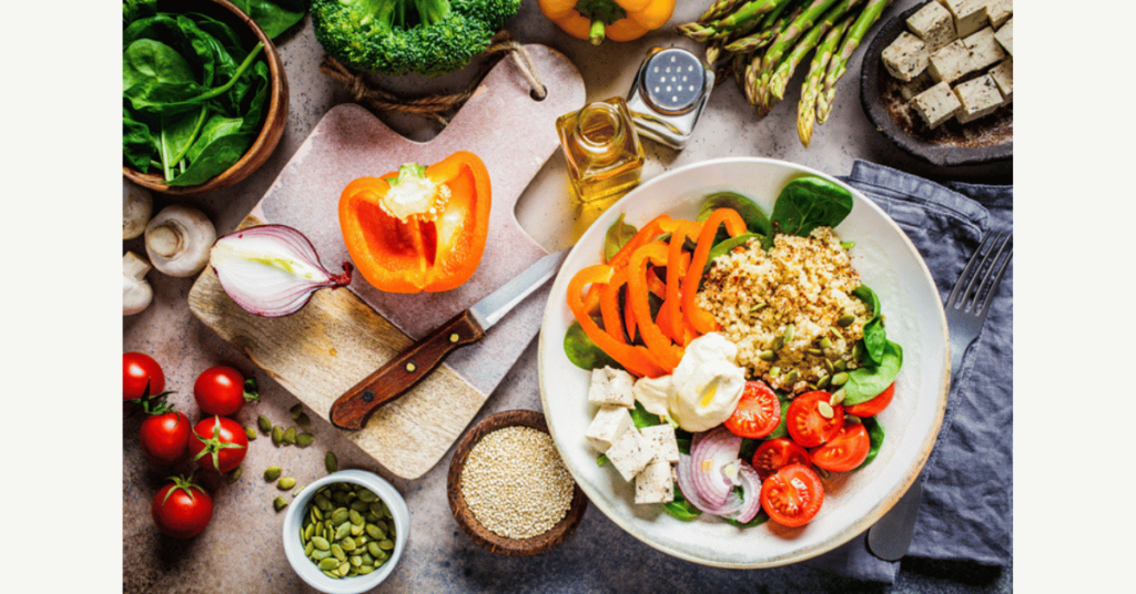 Cooking healthy vegan food. Ingredients for vegetable salad with tofu and quinoa on the table