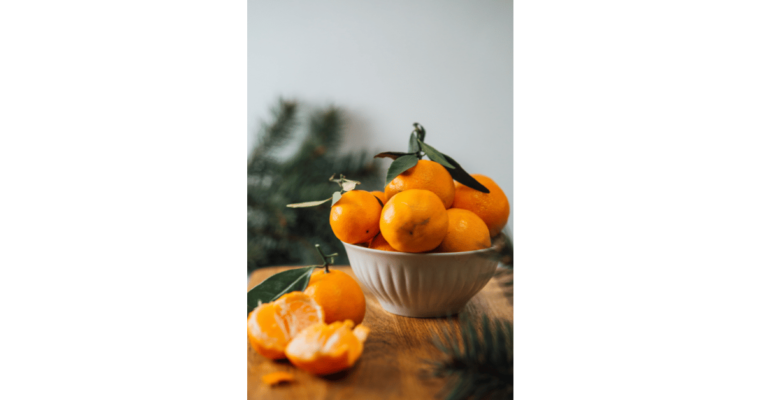 Orange fruits in white ceramic bowl Hanna Balan