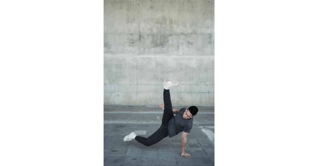 A strong Asian man dancing break on pavement