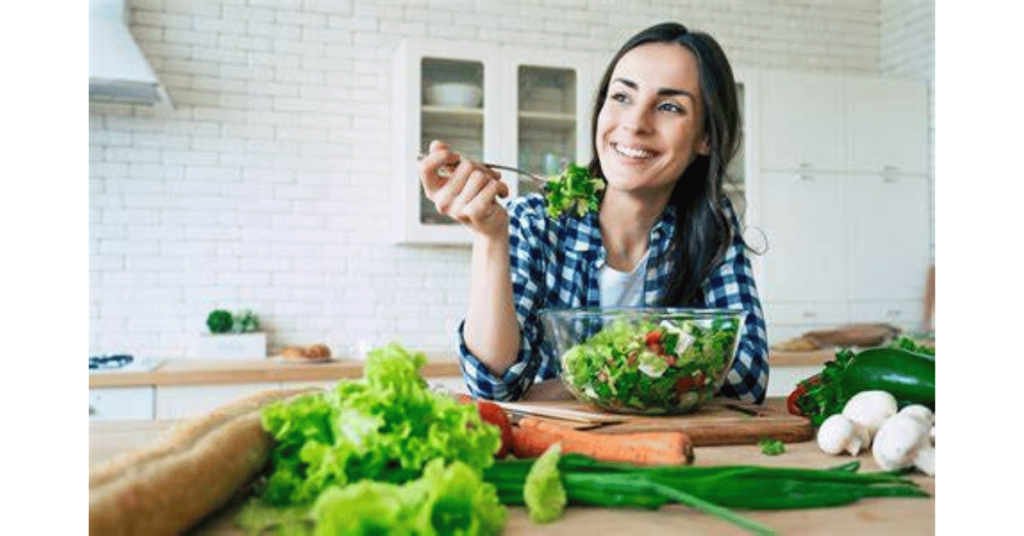 A woman sitting on a table with veggies