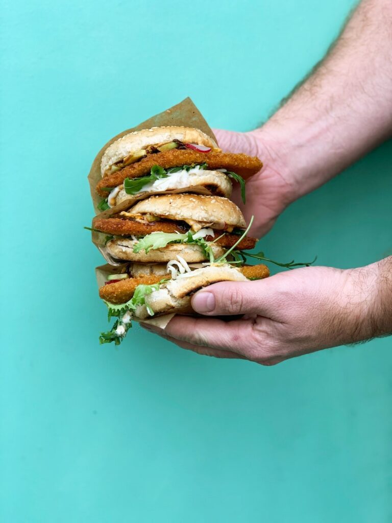 Hands holding plant-based burger