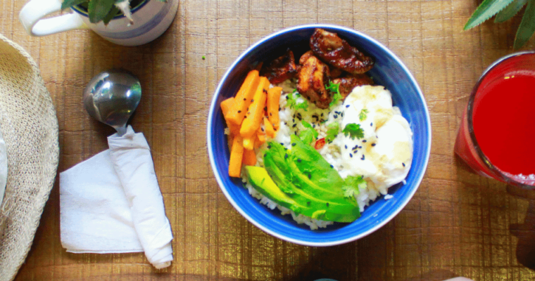 Plant-based food on the table with hand holding a smartphone.