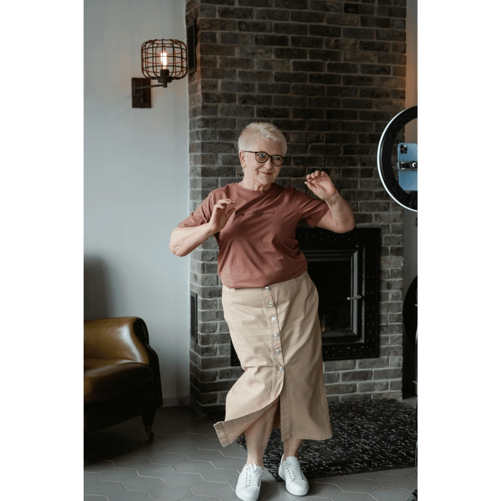 A woman dancing in front of a phone living on plant-powered longevity protocol.